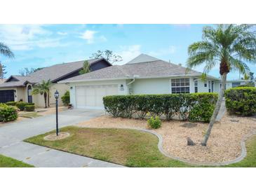 Inviting single-story home with a well-manicured lawn and a two-car garage in a desirable neighborhood at 14281 Palm Ter, Port Charlotte, FL 33953