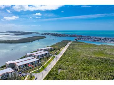 Stunning aerial view of condo complex with pristine waterfront access and vibrant surrounding scenery at 1651 Beach Rd # 311, Englewood, FL 34223