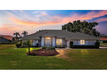 Stunning single-story home featuring a lush lawn and meticulously landscaped garden beds at 217 Rockwood Way, Englewood, FL 34223