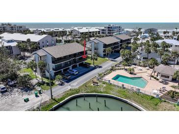 Lovely condo exterior features a pool, water access, and convenient covered parking at 2727 N Beach Rd # 113, Englewood, FL 34223