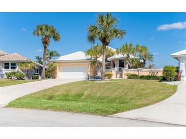Charming single Gathering home with a white tile roof, lush landscaping and a two car garage at 6 Windward Ct, Placida, FL 33946