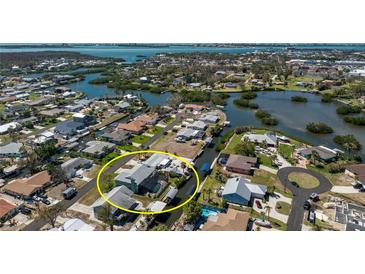 Aerial view of the home highlighting its waterfront location, screened-in pool, and neighborhood at 1052 Newton St, Englewood, FL 34224