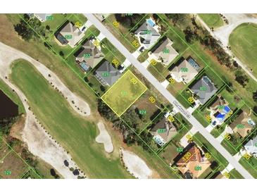 Aerial view of a residential property bordered by a golf course, showcasing a prime location at 65 Pinehurst Ct, Rotonda West, FL 33947