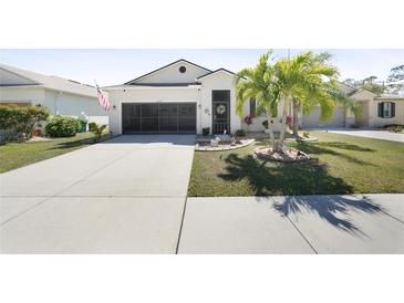 Charming single-story home featuring a two-car garage, landscaped yard, and well-maintained lawn at 10183 Winding River Rd, Punta Gorda, FL 33950