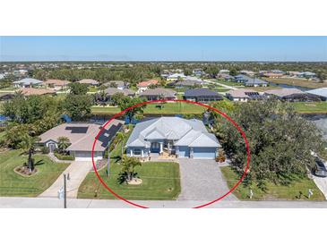 Beautiful single-story home with a well-manicured lawn and brick-paved driveway at 228 White Marsh Ln, Rotonda West, FL 33947