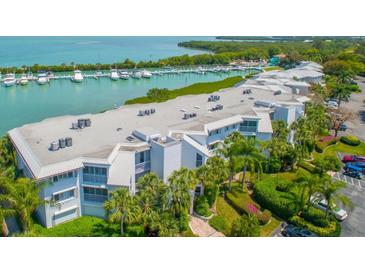 Stunning aerial view of the property with marina, beautiful landscaping and coastal views at 5858 Gasparilla Rd # 43, Boca Grande, FL 33921