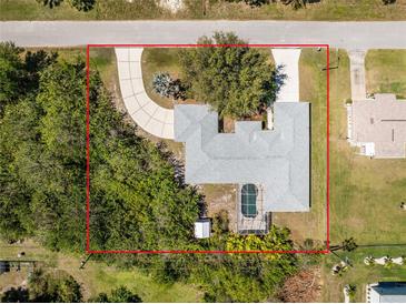 Beautiful aerial view of home with landscaped yard, circular driveway, and private screened-in pool at 7328 Yardley St, Englewood, FL 34224