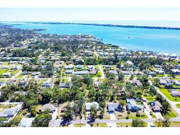 Expansive aerial view of a coastal neighborhood with lush greenery and beautiful waterfront scenery at 745 Sesame St, Englewood, FL 34223