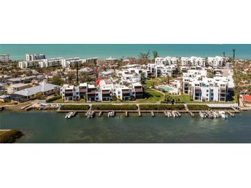 Stunning aerial view of waterfront condos with boat docks and community pool at 2955 N Beach Rd # D123, Englewood, FL 34223