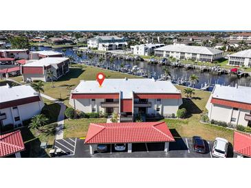 Waterfront condo features a red tile roof, on-site parking, and beautiful landscaping at 311 Garvin St # 209C, Punta Gorda, FL 33950