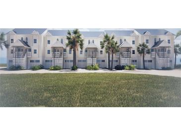 Beautiful white townhomes with metal roofs, lush landscaping, and private garages at 5800 Gulf Shores Dr # 33, Boca Grande, FL 33921