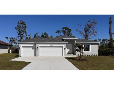 Charming single-story home featuring a three-car garage, well-maintained landscaping, and a classic design at 6602 David Blvd, Port Charlotte, FL 33981
