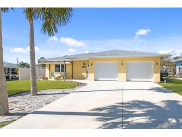 Charming single story home with a two car garage and a long concrete driveway at 840 Park Rd, Englewood, FL 34223
