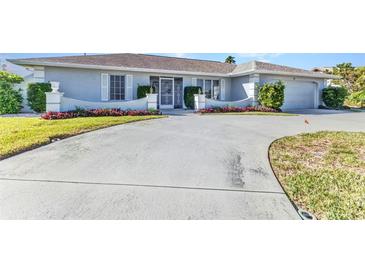 Charming home featuring a well-manicured lawn and a spacious driveway at 977 N Doral Ln, Venice, FL 34293