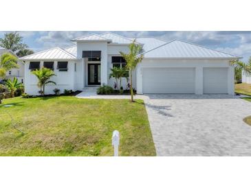 Beautiful one-story home with modern white exterior, black window accents, and well-manicured lawn at 18610 Ayrshire, Port Charlotte, FL 33981