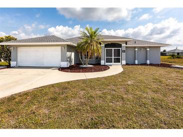 Charming single-story home featuring a well-maintained lawn and a welcoming entryway at 52 Mariner Ln, Rotonda West, FL 33947
