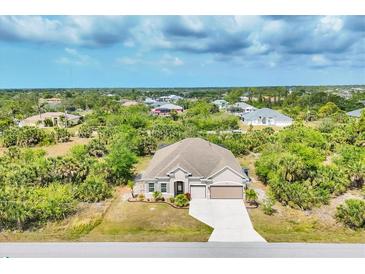 Well maintained single Gathering home with landscaped front yard, long driveway, and attached two car garage at 9283 Impala Cir, Port Charlotte, FL 33981