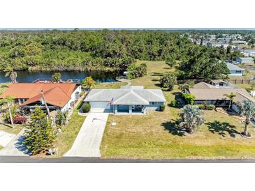 Charming one-story home with beautiful landscaping and a serene canal view at 1278 Lincoln Dr, Englewood, FL 34224