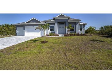 Beautiful single-story home with a well-manicured lawn and inviting entrance at 14526 Fort Worth Cir, Port Charlotte, FL 33981