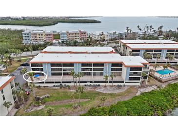 A multi-story building with a pool featuring balconies and proximity to waterways at 1551 Beach Rd # 207, Englewood, FL 34223