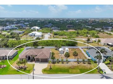 Sprawling home with large lot, RV parking, and tropical landscaping at 14527 Maysville Cir, Port Charlotte, FL 33981
