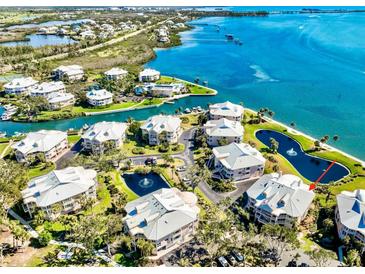 Stunning aerial view of waterfront condos with beautiful landscaping and access to the bay and intercoastal waterway at 11000 Placida Rd # 2702, Placida, FL 33946