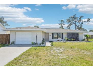 Charming single-story home with a well-manicured lawn, attached garage, and lovely curb appeal at 1365 Sussex Rd, Venice, FL 34293