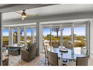 Bright dining area with beach views through large windows and comfortable seating at 17 Seawatch Dr, Boca Grande, FL 33921