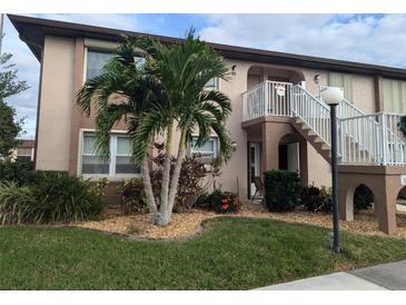Charming two-story condo with well-manicured lawn and tropical landscaping at 25100 Sandhill Blvd # T101, Punta Gorda, FL 33983