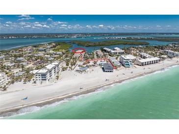 Breathtaking aerial view showcasing the beachfront property with turquoise waters and white sandy beach access at 2769 N Beach Rd # 105, Englewood, FL 34223