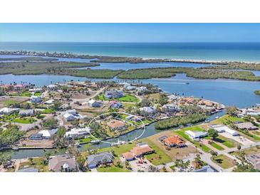 Waterfront home boasts direct gulf access and views of Lemon Bay, nestled in a vibrant coastal community at 30 Buccaneer Bnd, Placida, FL 33946