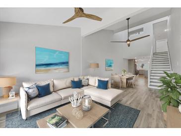 Bright living room featuring an open floor plan, modern decor, and seamless flow to the dining area at 6030 Boca Grande Cswy # B21, Boca Grande, FL 33921