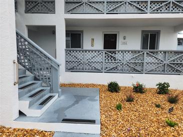 Charming condo building featuring gray lattice details, a well-maintained exterior, and inviting landscaping at 6800 Placida Rd # 1004, Englewood, FL 34224