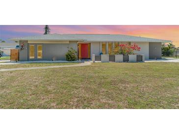 Charming single-story home featuring a well-maintained lawn and vibrant landscaping at 2140 Carnac St, Port Charlotte, FL 33952