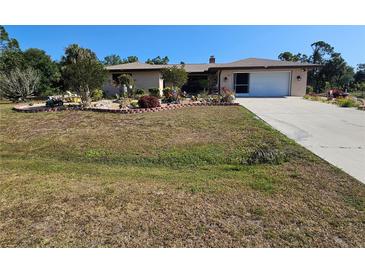 Charming one-story home with a two car garage and lovely landscaping at 2650 Colonade Ln, North Port, FL 34286