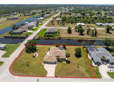 Beautiful aerial view of a canal-front property featuring a private pool, mature landscaping, and water access at 4 Pine Valley Ln, Rotonda West, FL 33947