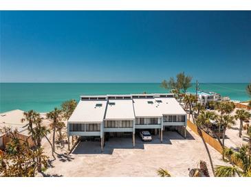 Stunning aerial view of a beachfront home featuring a modern design and beautiful ocean views at 5030 N Beach Rd # 1, Englewood, FL 34223