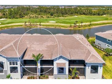 A stunning building showcasing large screened lanais for relaxing outdoor living, surrounded by lush landscaping at 12470 Wellen Golf St # 207, Venice, FL 34293