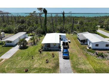 Charming single-story home with a well-maintained lawn and a scenic view of the water at 2906 Waterside Dr, Englewood, FL 34224