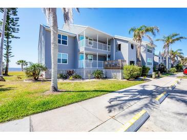 Charming waterfront condo featuring two stories with balconies, lush landscaping, and dedicated parking at 4410 Warren Ave # 306, Port Charlotte, FL 33953