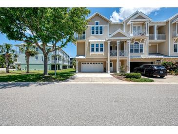 Beautiful multi-story townhouse with front yard and balconies near mature trees, and a two-car garage at 10411 Coral Landings Ln # 85, Placida, FL 33946