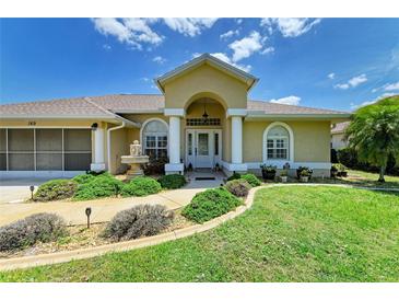 Charming single-story home with manicured lawn and a decorative front water fountain at 169 Fairway Rd, Rotonda West, FL 33947