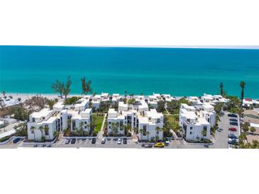 Stunning aerial view of beachfront condos with turquoise ocean backdrop at 2950 N Beach Rd # B324, Englewood, FL 34223