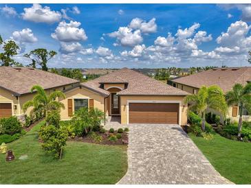 Charming single-story home featuring a well-manicured lawn, paver driveway and a two-car garage at 1836 W Isles Rd, Port Charlotte, FL 33953