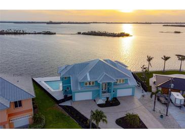 Lovely waterfront home featuring a backyard pool, a spacious driveway, and a beautiful view of the ocean at 1900 Illinois Ave, Englewood, FL 34224