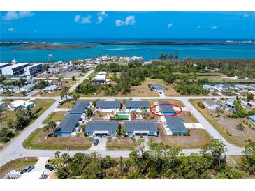 Stunning aerial view of a waterfront community with beautiful blue water, highlighting the home's coastal location at 1965 Louisiana Ave, Englewood, FL 34224