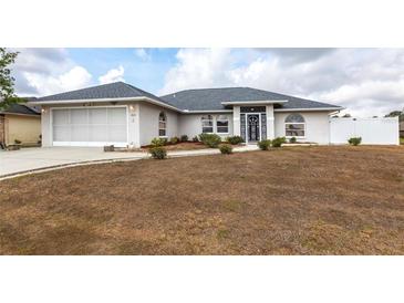 Charming single-story home with a clean landscape design and an attached two-car garage at 2125 Floribanna St, North Port, FL 34287