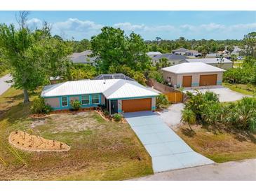 Charming single-Gathering home with a well-manicured lawn and a long driveway leading to an attached garage at 5250 Callaway St, Port Charlotte, FL 33981