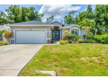 Charming single-story home with a well-manicured lawn and inviting double-door entry at 143 Crevalle Rd, Rotonda West, FL 33947