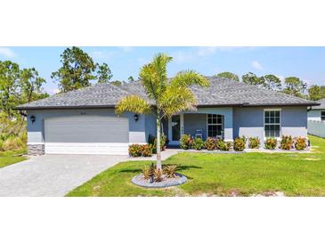 Charming single-story home featuring a well-manicured lawn, palm tree, and attached two-car garage at 2678 Alva St, North Port, FL 34291